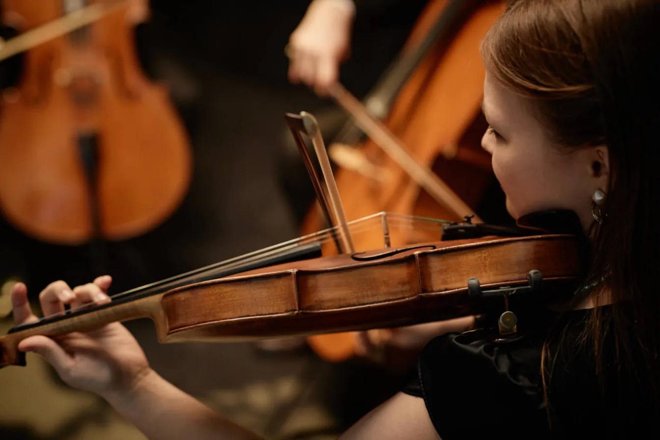 A violinist performs in an orchestra